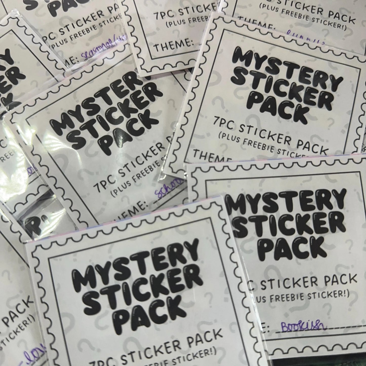 Multiple 'Mystery Sticker Pack' packages with black text on a white background.
