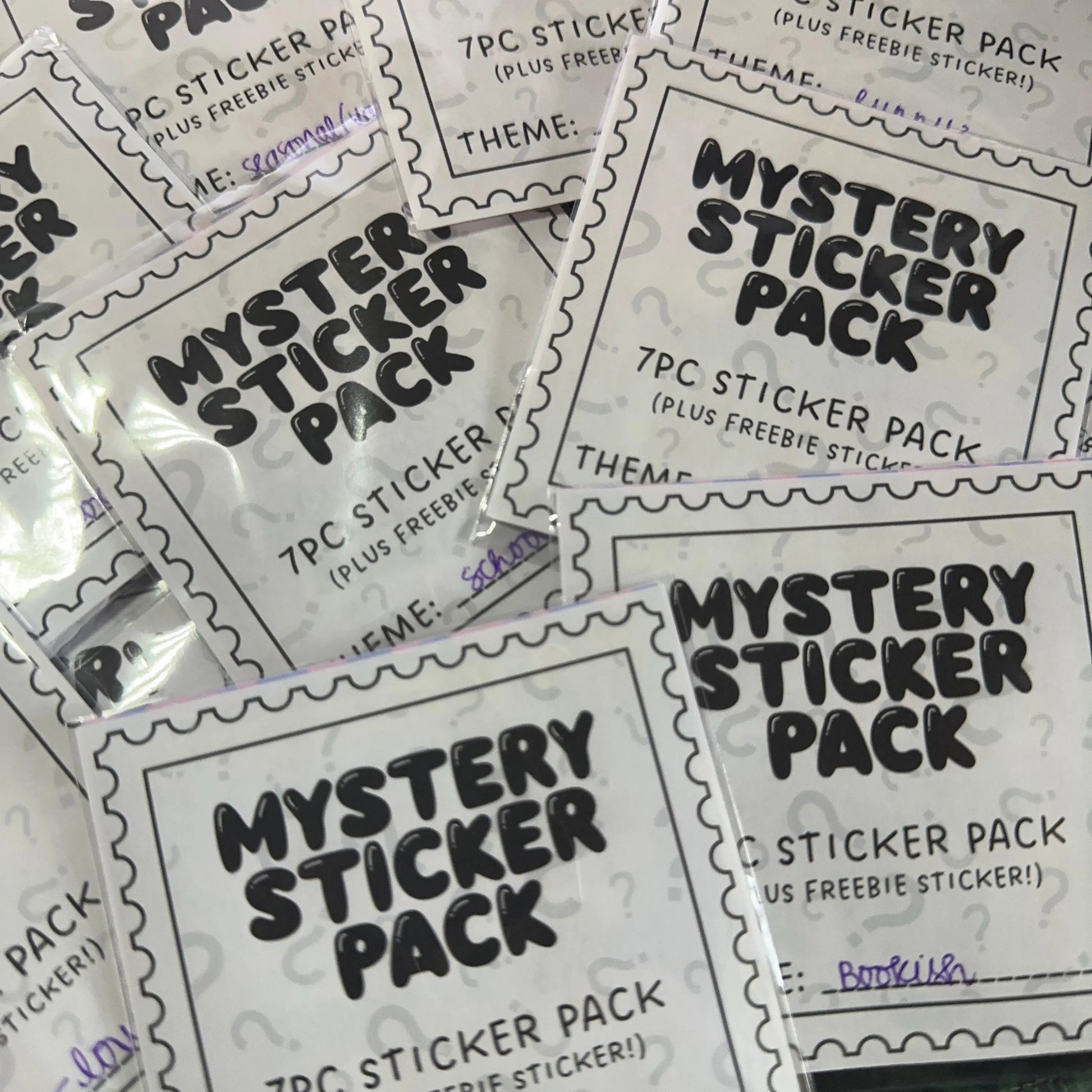 Multiple 'Mystery Sticker Pack' packages with black text on a white background.